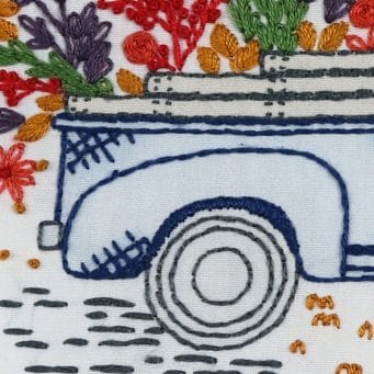 Satin stitch is used here for the shadowing curve around the top of the tire in Vintage Truck.