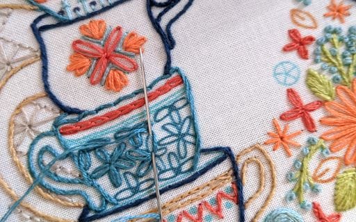 closeup of the split stitch used on stacked tea cups in tea themed embroidery design