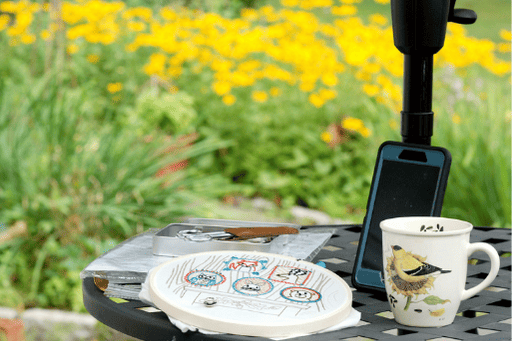 embroidery project outside with tea and a show