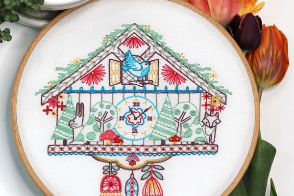 embroidery project with vintage house-styled cuckoo clock 