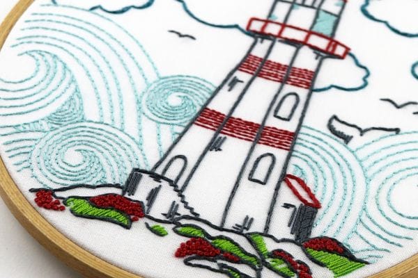 embroidery hoop-art with lighthouse and french knot blossoms