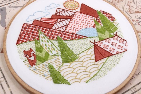 embroidery project featuring mountains and camping