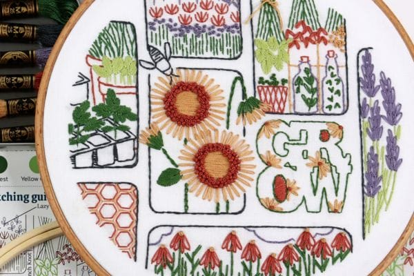 Embroidered hoop-art of gardening motifs in Grow.