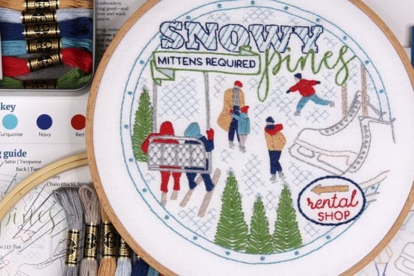 Embroidered hoop art of skiing and ice skating