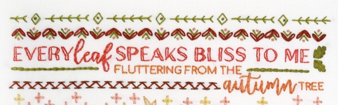Embroidered detail from traditional embroidery stitch sampler with fall themes