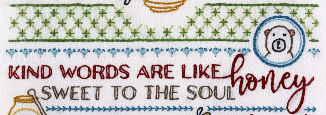 Embroidered detail from traditional embroidery stitch sampler with honeybee themes