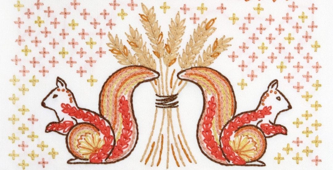Embroidered detail from traditional embroidery stitch sampler with fall themes