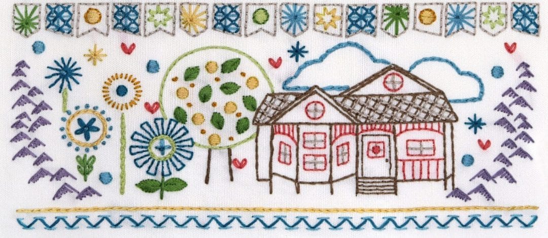 Embroidered detail from traditional embroidery stitch sampler with home themes