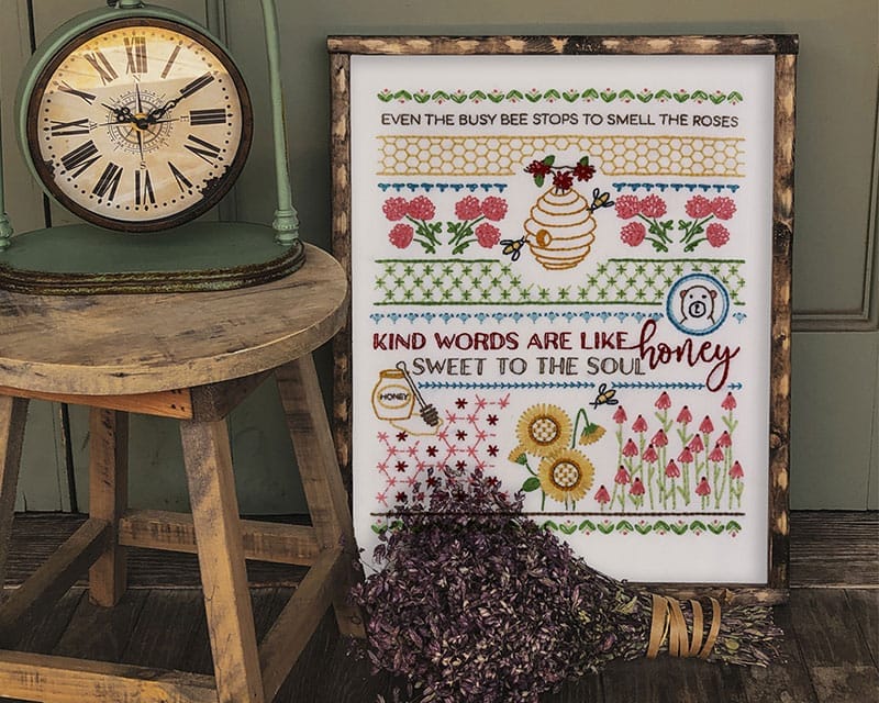 Traditional embroidery stitch sampler with honeybee themes