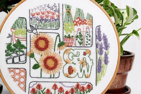 Finished embroidery hoop-art of sunflowers and gardening motifs