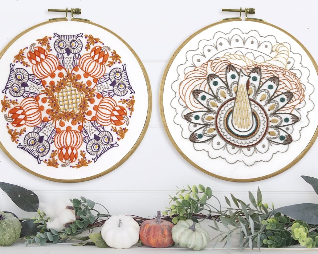 Finished fall in-the-hoop embroidery projects hanging over decorated mantle.