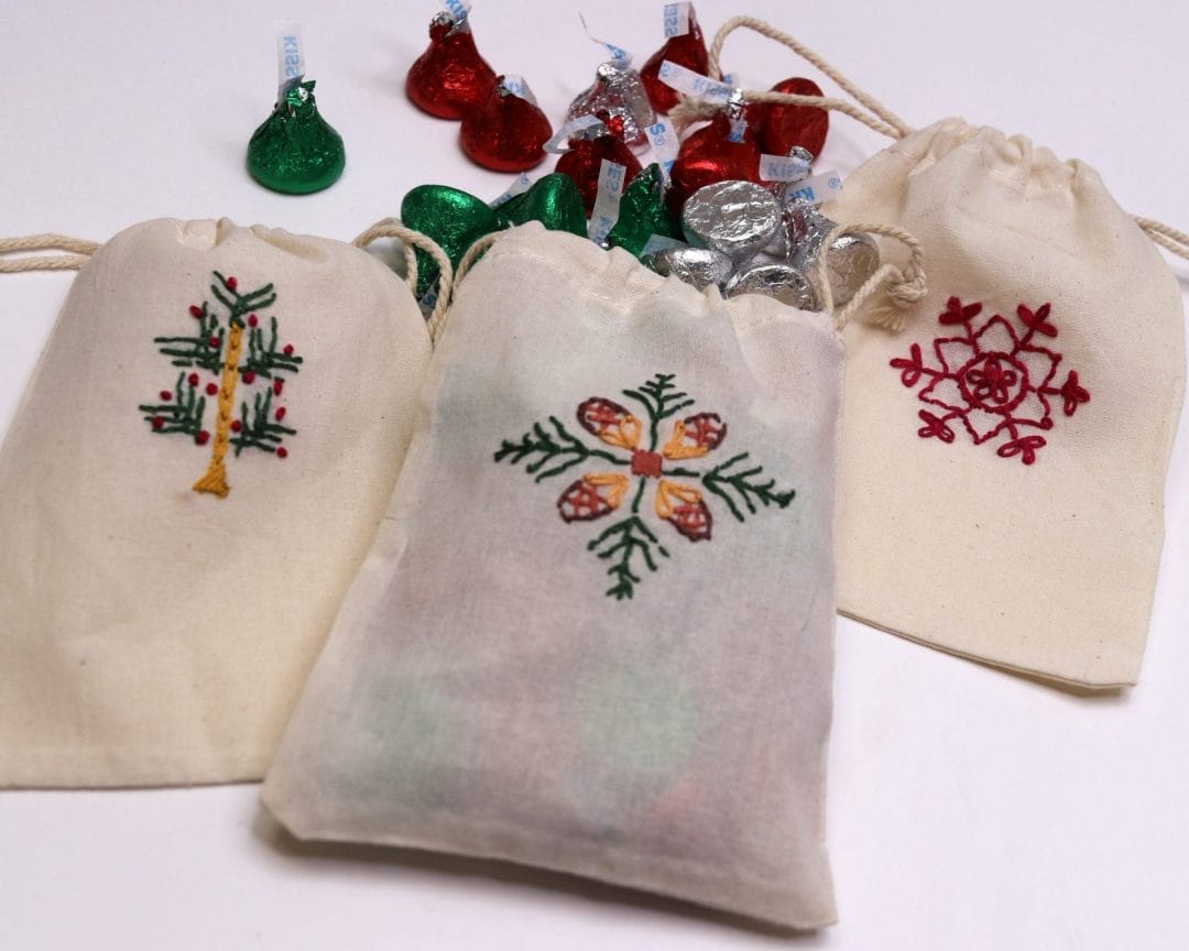 small canvas gift bags embroidered with holiday motifs