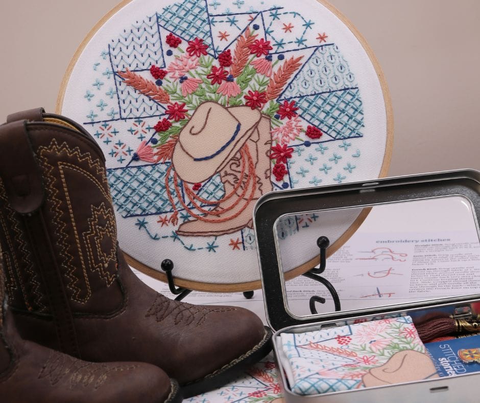 displayed embroidery hoop art with western motif