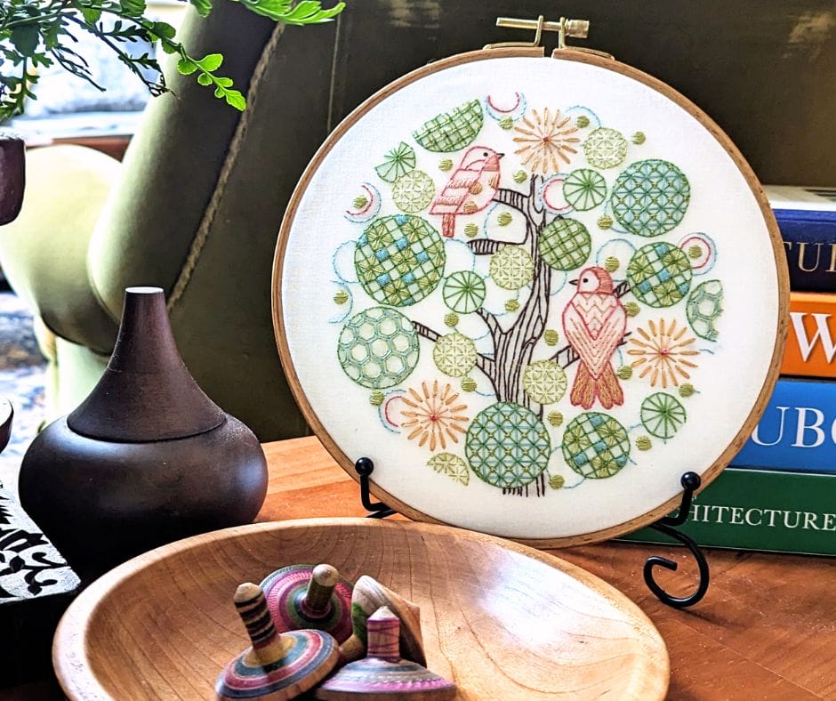 displayed embroidery hoop art with tree of life motif