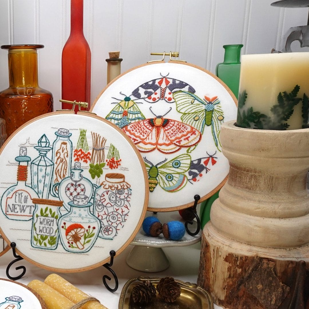 fall embroidery vignette with potions and moths on dispaly in home