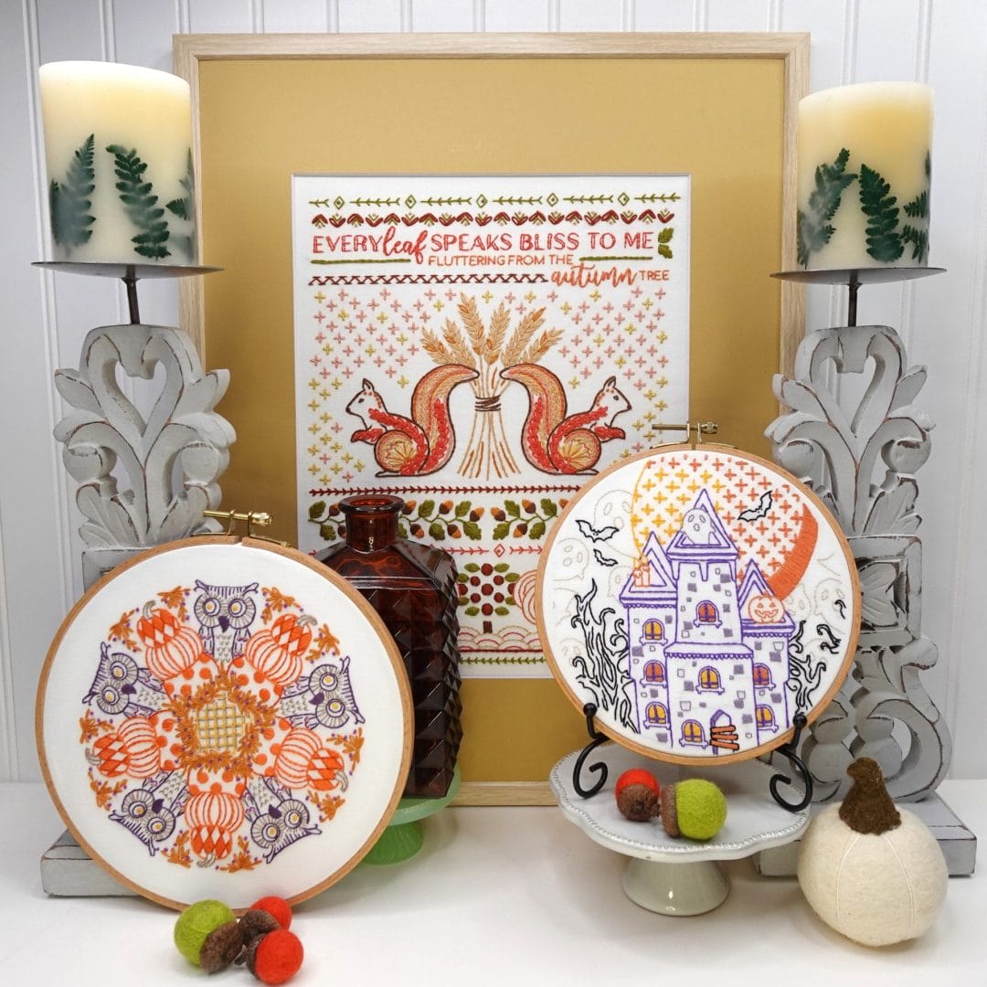 fall themed styled vignette with fall sampler, pumpkins and owls and spooky house embroidery hoopart