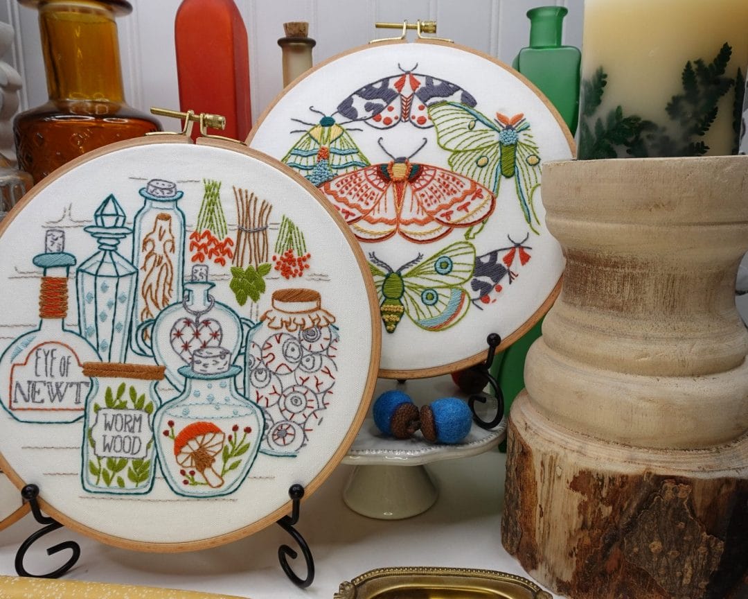 fall themed styled vignette with potions and moths hoopart