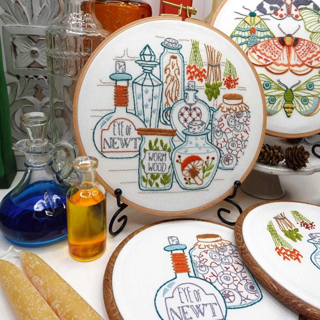 cozycore-inspired vignette with embroidery hoop featuring witchy potions